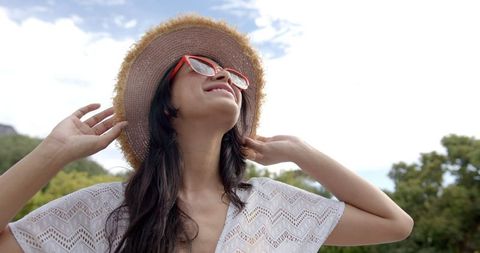Carefree Teenage Girl Enjoying Sunny Day in Straw Hat
