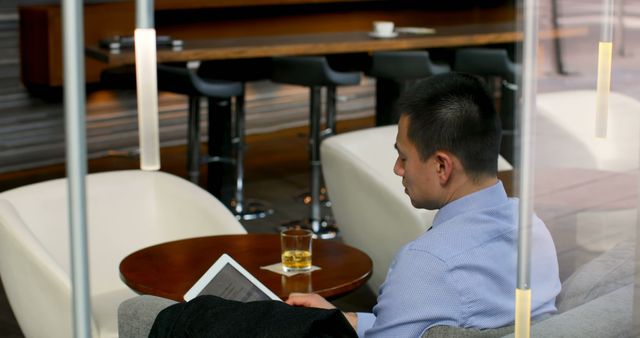 Businessman Working on Tablet in Modern Cafe - Download Free Stock Images Pikwizard.com