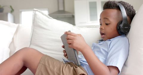 Young Boy Relaxing with Tablet and Headphones at Home - Download Free Stock Images Pikwizard.com