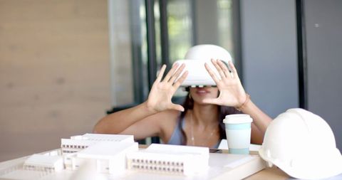Woman Using VR Headset for Architecture Model Exploration
