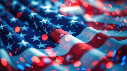 American flag with festive red and blue bokeh lights