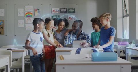 Diverse Students Engaging with Teacher Using Tablet in Classroom