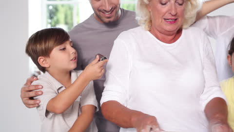 Multigenerational Family Making Cookies Together in Kitchen