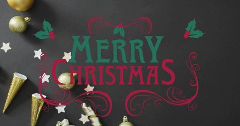 Displaying merry christmas lettering on charcoal tabletop with gold ornaments and holly