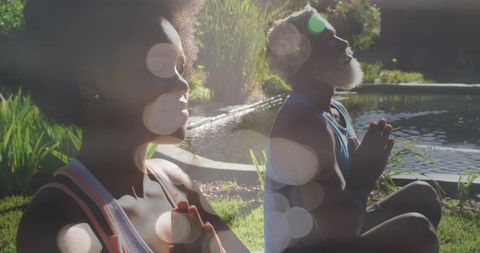 African American Couple Meditating in Sunlit Garden