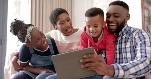 Happy African American Family Laughing and Using Tablet Together - Download Free Stock Images Pikwizard.com