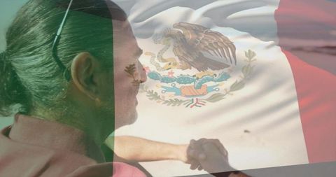 Mature Man Gazing at Shore with Mexican Flag Overlay Clasping Hands in Contemplation