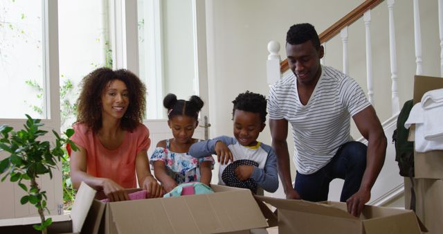 Happy Family Unpacking Boxes in New Home Together - Download Free Stock Images Pikwizard.com