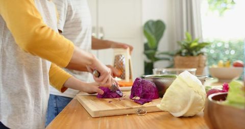 Couple Preparing Cabbages Together in Home Kitchen