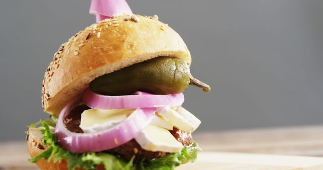 Fresh Gourmet Burger with Pickles and Onions on Sesame Bun - Download Free Stock Images Pikwizard.com