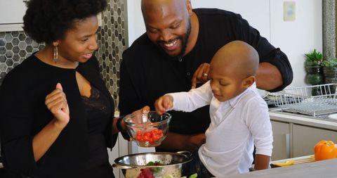Happy African American Family Cooking Together in Modern Kitchen