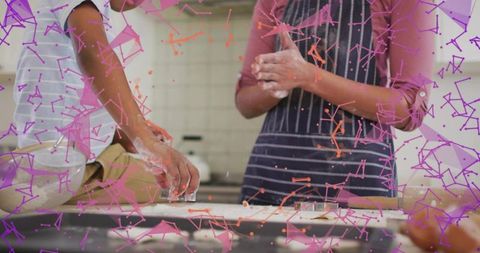 Parent and child baking cookies with flour and cutter, purple tech overlay, home kitchen teamwork
