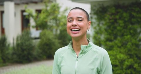 Smiling Woman in Green Jacket Enjoying Outdoor Experience
