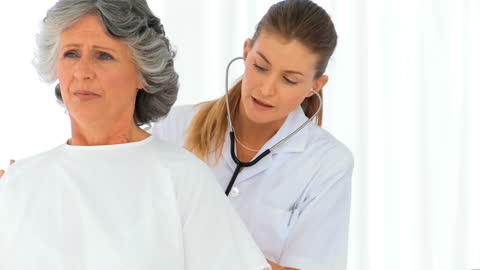 Healthcare Professional with Mature Patient Using Stethoscope