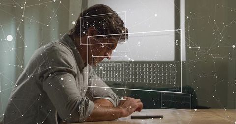 Man Using Augmented Reality Interface Over Smartphone While Annotating Documents at Desk