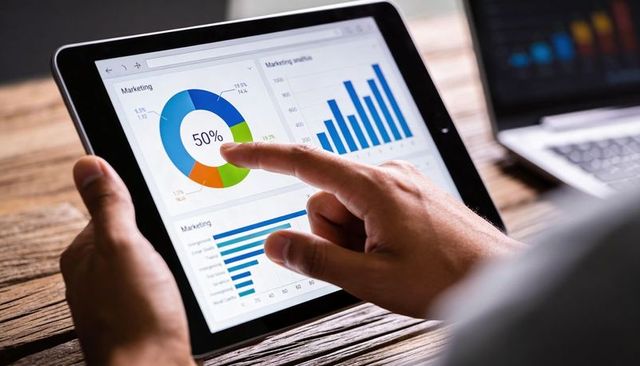Tapping tablet dashboard showing 50% doughnut metric on touchscreen for business analytics