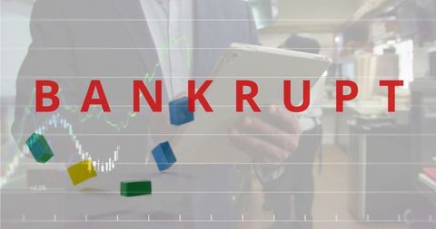 Bankrupt overlay on businessman holding tablet with falling blocks and stock charts