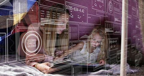 Mother and daughter bonding in blanket fort using tablet with digital hud overlays