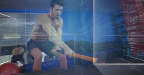 Man Training with Sledgehammer in Intense Gym Workout