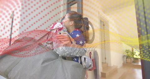 Military homecoming reuniting at front door embracing with duffel bag in cozy hallway