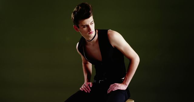 Stylish Young Man in Black Tank Top Posing Against Dark Background - Download Free Stock Images Pikwizard.com