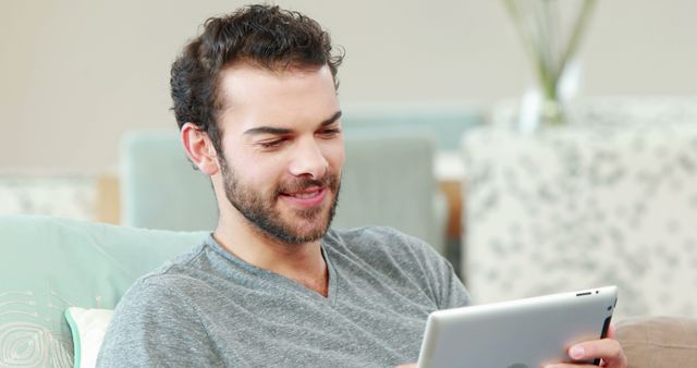 Relaxed Man Reading on Digital Tablet at Home - Download Free Stock Images Pikwizard.com