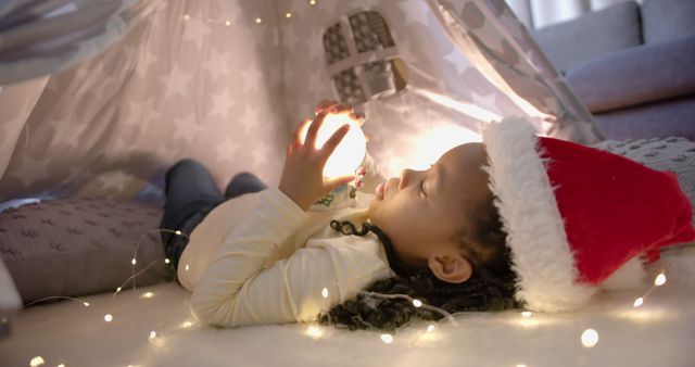 Child Enjoying Christmas Magic in Cozy Indoor Fort - Download Free Stock Images Pikwizard.com