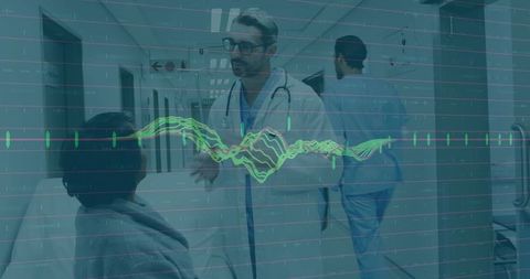 Doctor consulting patient in hospital corridor with ecg data overlay for telehealth