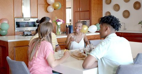 Group of friends enjoying casual meal together at home