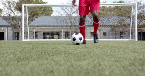 Soccer Player in Red Uniform Practicing Skills on Field