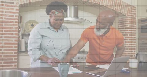 Senior Couple Managing Finances at Home Table