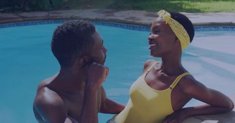 Couple relaxing and talking at backyard pool wearing yellow swimwear intimate summer moment