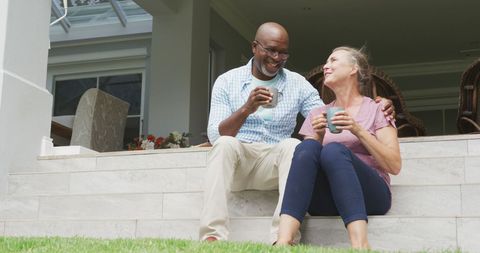 Senior Couple Enjoying Coffee Relaxing Outdoors in Sunshine