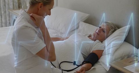 Nurse Monitoring Blood Pressure of Senior Patient at Home