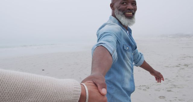 Senior Couple Holding Hands on Foggy Beach - Download Free Stock Images Pikwizard.com