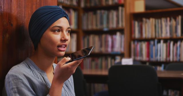 Young Woman Using Voice Assistant on Smartphone in Library - Download Free Stock Images Pikwizard.com