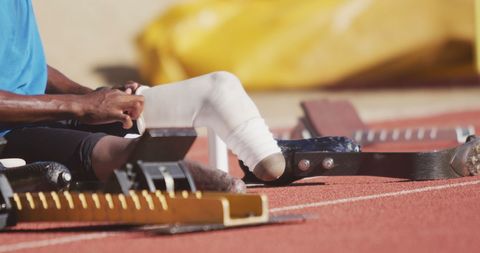 African American Athlete Fitting Prosthetic Legs on Track