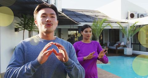 Diverse Couple Practicing Yoga Near Pool at Home in Sunlight