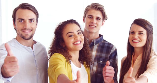Diverse group of young adults giving thumbs up - Download Free Stock Images Pikwizard.com