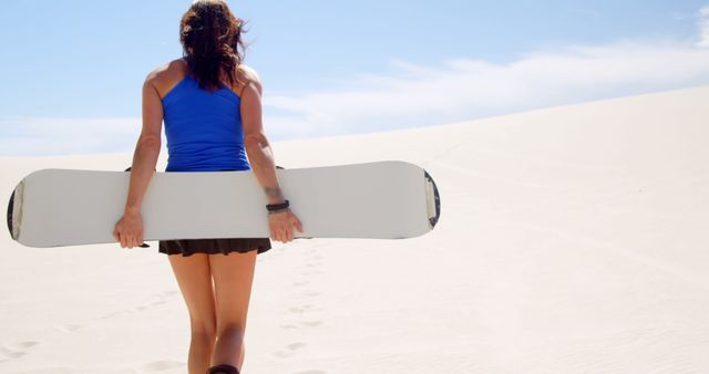 Woman Carrying Snowboard in Desert - Download Free Stock Images Pikwizard.com