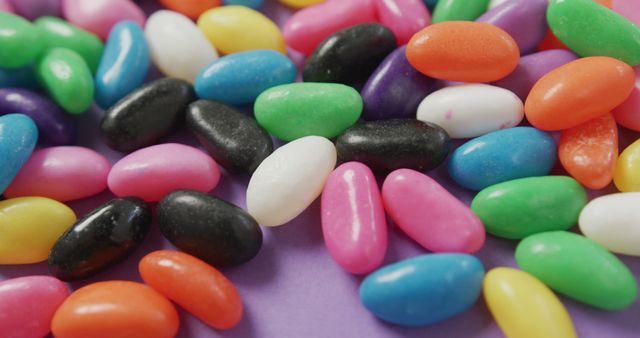 Close-up of Colorful Jelly Beans on Purple Background - Download Free Stock Images Pikwizard.com