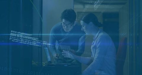 IT Technicians Analyzing Data in Modern Server Room