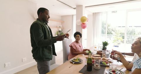 Friends Gathering for Lunch, Toasting and Sharing Memories at Home