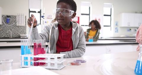Students Conducting Experiments with Pipettes in School Science Lab