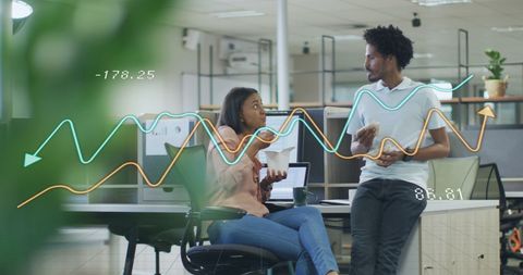 Diverse Professionals Analyzing Financial Growth Data in Modern Office