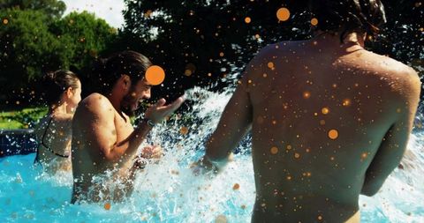 Friends splashing in backyard pool during summer party, laughing and enjoying sunny day