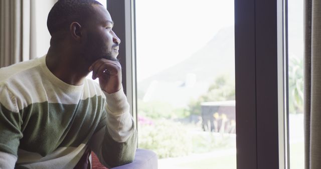 Contemplative Man Looking Out Window On Busy Morning - Download Free Stock Images Pikwizard.com