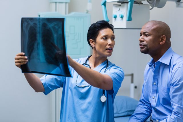 Nurse discussing x-ray with patient in hospital