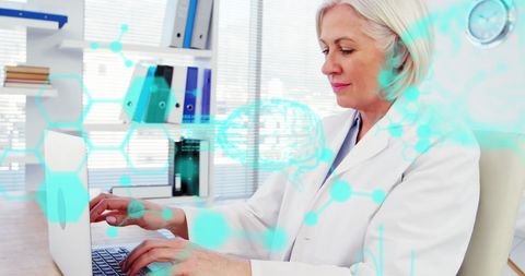 Senior Doctor Analyzing Medical Data on Laptop in Modern Hospital - Download Free Stock Images Pikwizard.com