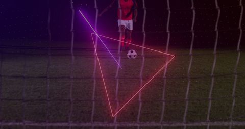 Neon Effects Enhance Football Player Kicking Ball at Stadium
